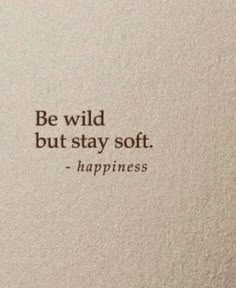 a white wall with a quote on it that says, be wild but stay soft happiness