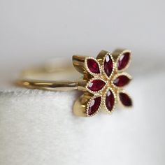 a gold ring with red stones on it