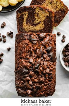 sliced loaf of chocolate banana bread on top of paper next to bowls of bananas and coffee beans