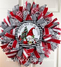 a red and white christmas wreath with santa clause on it