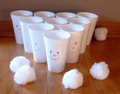 there are many cups that have cotton balls on the floor