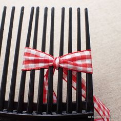 a black comb with a red and white bow on it