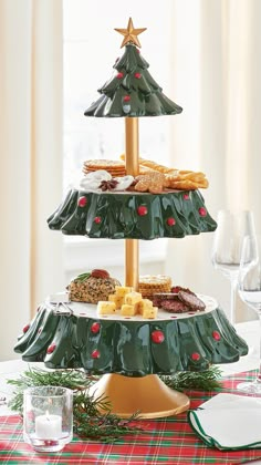 three tiered christmas tree platter with cheeses and crackers on the top