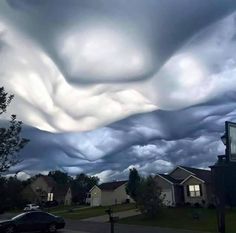 some clouds are in the sky over houses