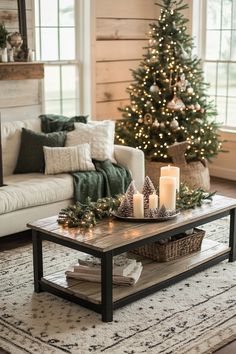 a living room with a christmas tree in the corner and candles on the coffee table