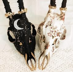 two black and white animal heads with gold accents