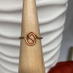 a gold ring sitting on top of a wooden stand