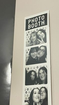 a photo booth sign hanging on the wall