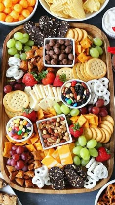 a platter filled with lots of different types of snacks and desserts on it