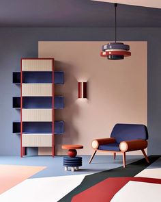 a living room with a chair, book shelf and lamp on the wall next to it