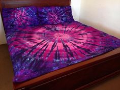 a bed with purple and blue designs on it