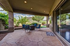 a patio with chairs and tables on it