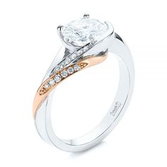 a diamond ring with two tone gold and white diamonds on the band, set in 18k