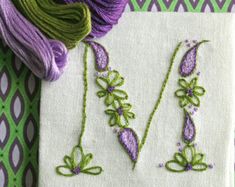 some purple and green items are laying on a white piece of cloth next to each other