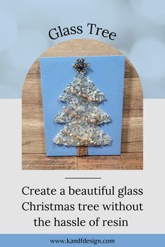 a christmas tree made out of glass is displayed on a wooden table with text overlay