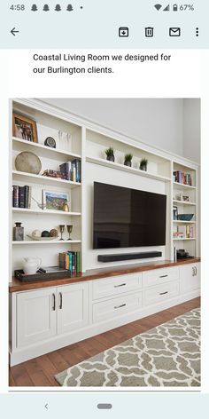 a living room with white bookcases and a flat screen tv