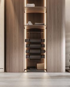 an empty room with shelves and boxes on the floor, in front of a wooden wall