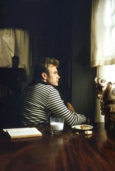 a man sitting at a table in front of a window