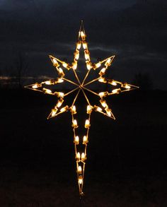 a lighted christmas star in the dark