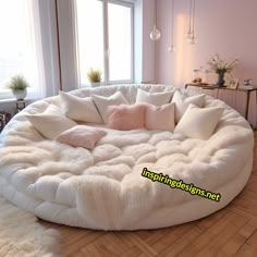 a large white round couch in a living room