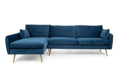 a blue couch sitting on top of a white floor next to a wooden leg chair