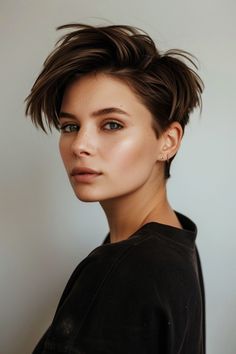 An edgy ear-length pixie cut that boasts tapered sides and a voluminous top, creating a bold and striking style statement with a touch of sophistication. See more below. Graduation Hairstyles For Black Women, Pixie With Bangs, S Haircut, Summer Hair Trends, Tapered Sides, Blonde Tips, Asymmetrical Pixie, Haircut Long, Curly Pixie