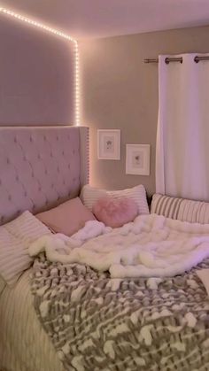 a bed with white and pink blankets on it