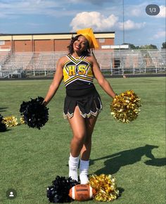 a cheerleader standing in the grass with her pom poms and footballs