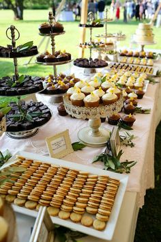 a table topped with lots of cupcakes and desserts on top of it