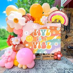 an assortment of balloons and decorations are on display in front of a house with a sign that says,'fly us a tube '