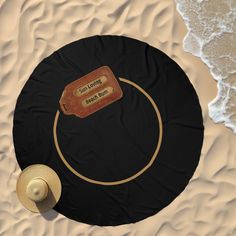 an aerial view of a table with a hat and luggage tag on it in the sand