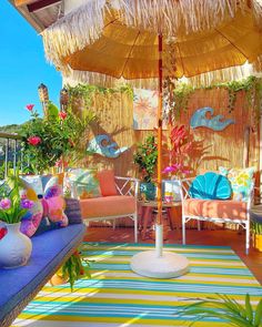 an umbrella and some chairs on a deck