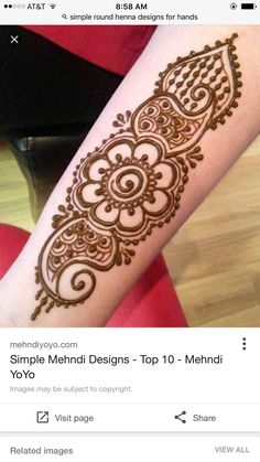 a woman's arm with henna tattoos on it