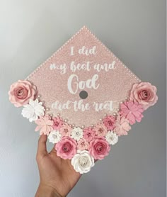 someone is holding up a pink and white graduation cap with flowers on it that says, i did my best and god at the rest