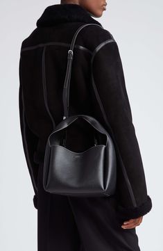 Sculpted from grained leather in a cube silhouette, this bucket bag offers plenty of room for the everyday essentials while retaining a lightweight feel. Carry the versatile look by the folded handle or attach the adjustable strap for shoulder wear. Bridge-clip closure Top carry handle; removable, adjustable shoulder strap Interior wall pocket; card slot Leather Made in Italy Designer Handbags Top Handle Bucket Bag With Removable Pouch For Work, Workwear Bucket Bag With Detachable Handle, Workwear Bag With Detachable Handle In Bucket Shape, Detachable Handle Bucket Bag For Work, Everyday Structured Bucket Bag With Removable Pouch, Bucket Shoulder Bag With Handle Drop For Work, Leather Box Bag With Detachable Handle In Bucket Shape, Leather Box Bag With Detachable Handle And Bucket Shape, Structured Leather Bucket Bag For Everyday