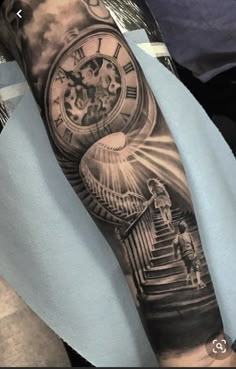 a man's arm with a clock and stairs tattoo on the left side of his arm