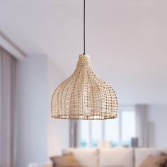 a living room filled with furniture and a light fixture hanging over the top of it