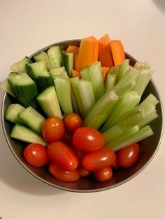 a bowl filled with lots of vegetables on top of a table