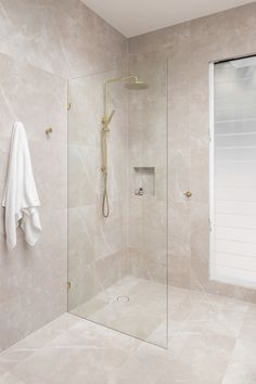 warmth is added to the bathroom through sandy tiles and oak cabinetry. Brushed brass tapware is featured to add additional warmth to the space. Peel And Stick Tiles, Bathroom Ensuite, Stick Tiles, Neutral Bathroom, Bathroom Tapware