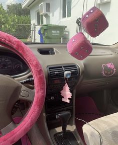 the interior of a car with hello kitty decorations hanging from it's dash board