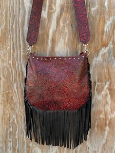 Made of extremely soft genuine leather Leather fringe along the bottom and sides Nail head trim along the top 1 pocket inside - 1 pocket outside Zipper closure for the entire purse 2″ wide leather strap - approx 27″ strap drop Extremely light weight Purse measures approx: 12″ L x 10″ H - laying flat Last photo is for size reference only Pink Fringe Bag, Leather Fringe Handbag, Red Leather Purse, Fringe Handbags, Fringe Purse, Fringe Bags, Cross Body Purse, Western Leather, Shoe Covers