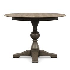 a round wooden table with two pedestals at the base and an oval wood top