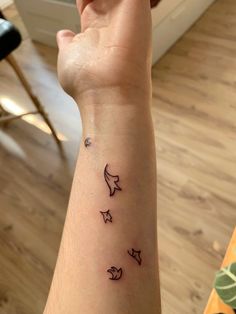 a woman's arm with three small stars on it