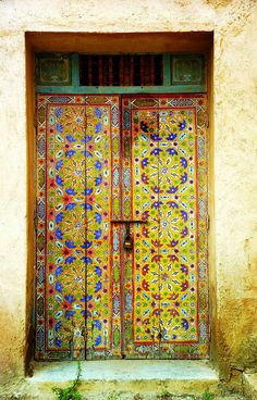 an ornate door with colorful designs on it