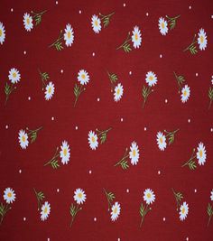 a red background with white daisies and green leaves on it's side,