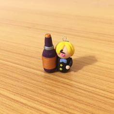 a small toy is sitting next to a crayon