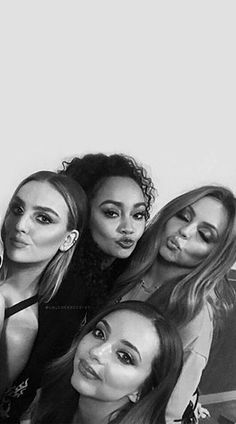 the girls are posing together in black and white