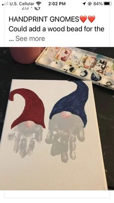 two gnomes handprinted on canvases sitting next to each other