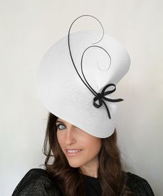 Elegant Black and white wedding fascinator hat Bride. This white fascinator hat is decorated with two black feathers that create an original draw and a black bow. It is a beautiful woman hat perfect for Special Occasion like weddings, Royal Ascot horse races, cocktails, Kentucky Derby, Tea Party, Baptism... This wedding hat is mounted on a headband that allows to tilt the hat to the liking of each one. If you would like to change any colors or items of the hat please contact us to meet your need Elegant White Adjustable Top Hat, Fitted White Hat Headpiece, White Adjustable Top Hat For Races, White Adjustable Headpiece With Short Brim, White Adjustable Mini Hats For Party, Adjustable White Mini Hats For Party, White Fitted Fascinator For Royal Ascot, White Top Hat With Short Brim For Party, Fitted White Headpiece For Church