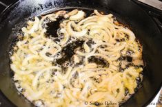 a skillet with some noodles cooking in it